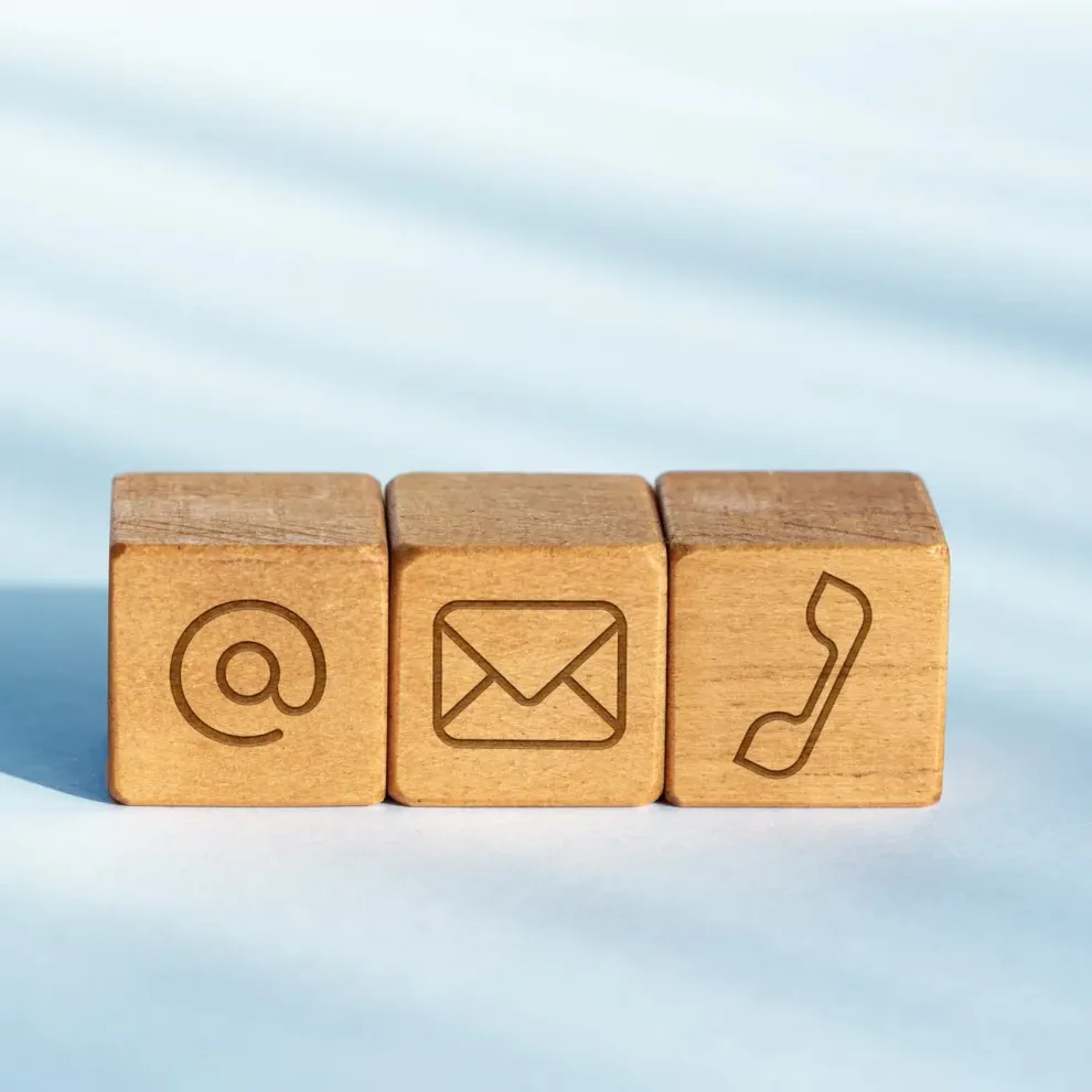 Contact us concept. Wooden dices with email, mail and telephone icon Contact us concept. Wooden dices with email, mail and telephone icon